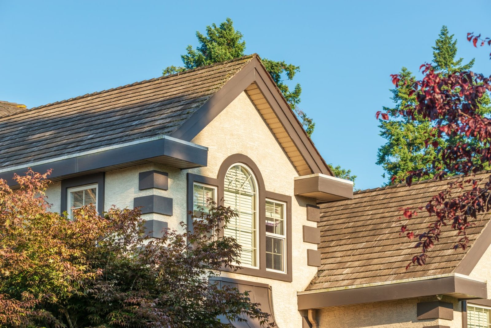 Worn shingles inspected on a St. Louis roof, a common FAQ subject